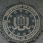 FBI agents analyzing blockchain data to track illicit cryptocurrency transactions.