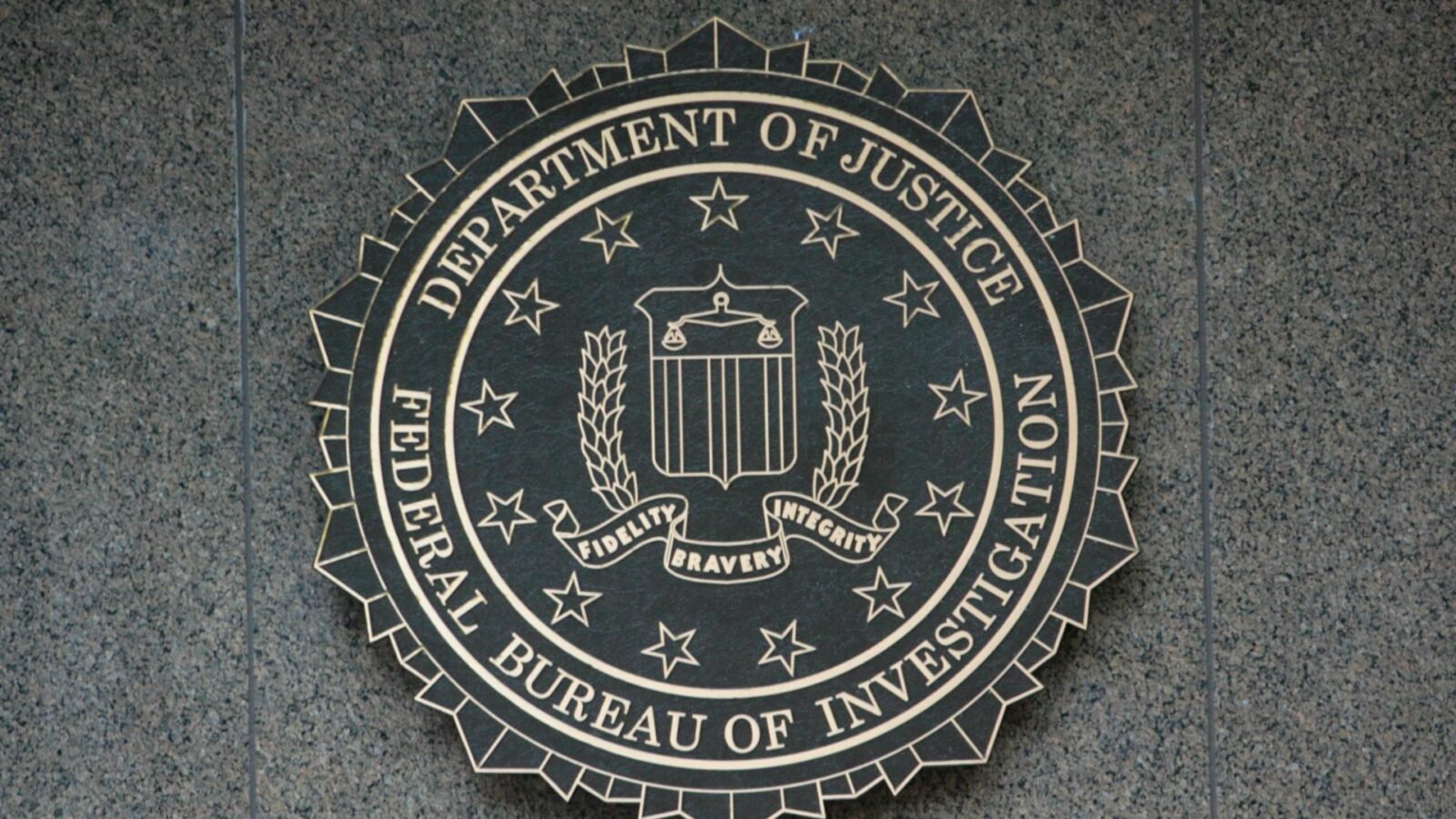 FBI agents analyzing blockchain data to track illicit cryptocurrency transactions.