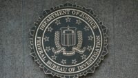 FBI agents analyzing blockchain data to track illicit cryptocurrency transactions.
