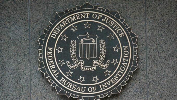 FBI agents analyzing blockchain data to track illicit cryptocurrency transactions.