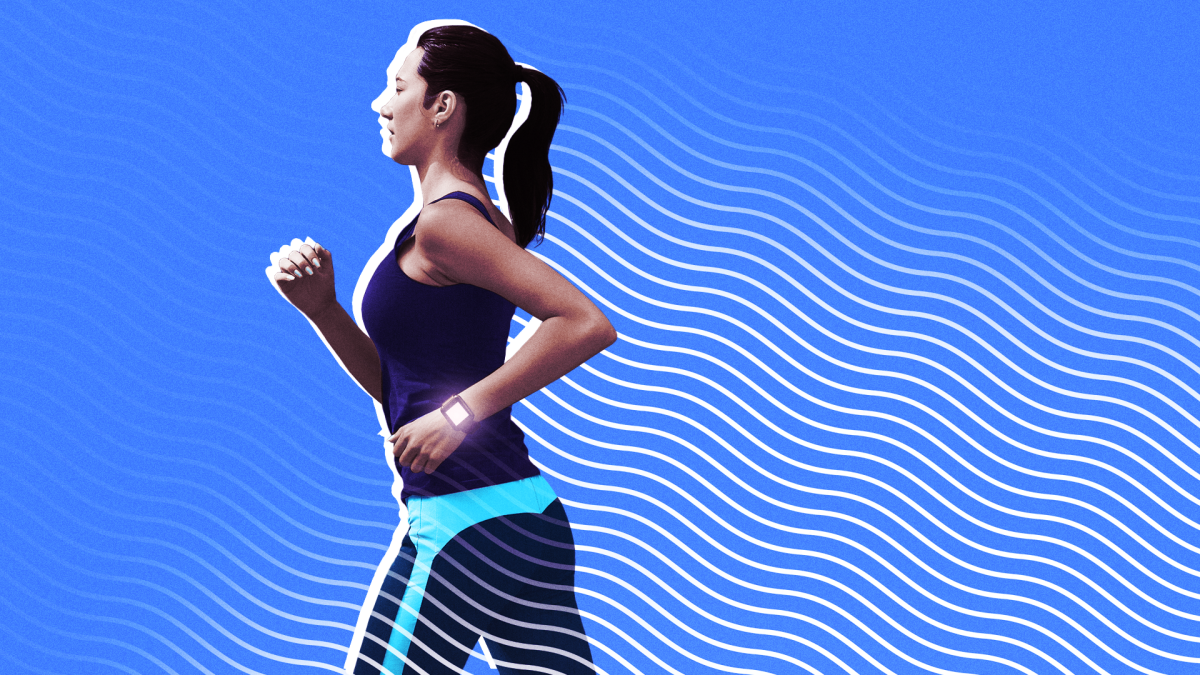 A person looking at their fitness tracker displaying calorie burn data on their wrist