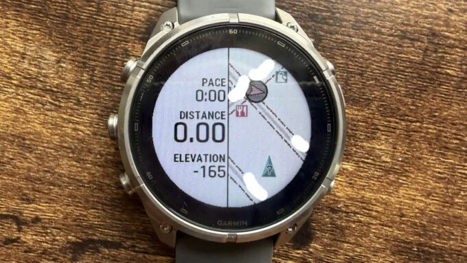 Close-up view of the Garmin Fenix 9 Pro Solar 47mm Titanium GPS Smartwatch on a wrist, displaying a map or activity data.