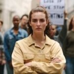A young person, possibly Gen Z, with a thoughtful or determined expression, symbolizing the economic challenges faced by the generation.