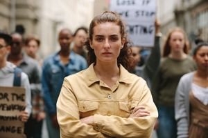 A young person, possibly Gen Z, with a thoughtful or determined expression, symbolizing the economic challenges faced by the generation.