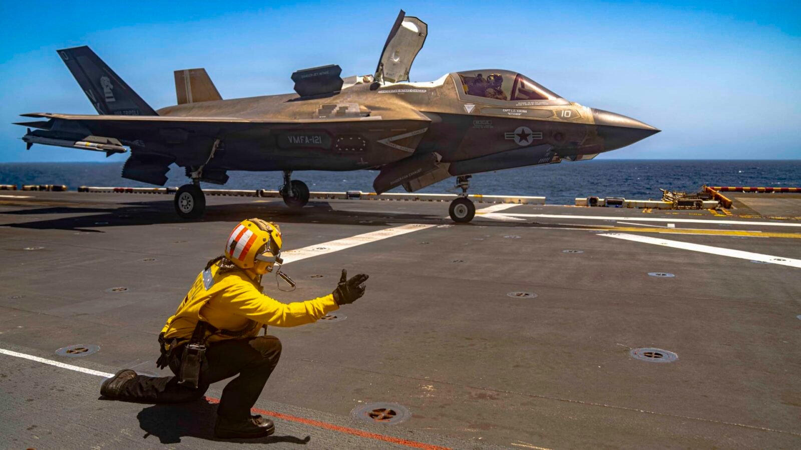 An F-35B Lighting II jet taking off from the flight deck of the America-class amphibious assault ship USS Tripoli.