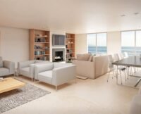 Vue aérienne d'un quartier résidentiel moderne au Maroc, avec des immeubles neufs et des grues de construction en arrière-plan, symbolisant le défi de l'accès au logement.