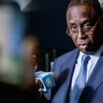Macky Sall, ancien président du Sénégal, à New York, le 22 avril 2026, lors d'un événement. Il porte un costume sombre et une cravate claire.