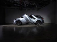 Surreal automotive sculptures by MSCHF, a Lexus RZ 450e twisted into a circle and an RX 450h+ spiraled, displayed at MOTOMORPHOSIS exhibition.
