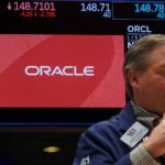 An Oracle logo displayed on a trading screen at the New York Stock Exchange, reflecting the company's stock performance.