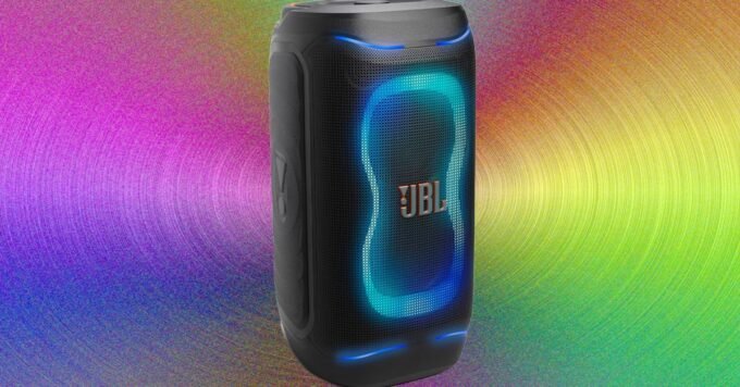 A vibrant party speaker with LED lights, playing music at a lively gathering, showcasing its portability and powerful sound.