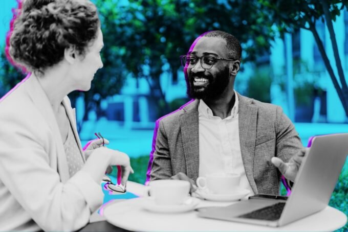 A diverse group of entrepreneurs discussing investment strategies around a table, symbolizing private capital collaboration.
