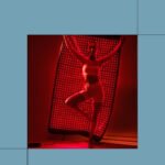 A HigherDOSE Full Body Red Light Mat laid out, possibly with a person relaxing on it or draped over them, showcasing its flexible design.