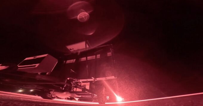 An illustration of a Star Catcher satellite beaming a laser energy beam to another satellite in Earth's orbit, with the sun in the background.