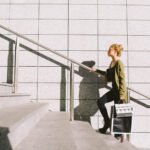 Person climbing a flight of stairs, symbolizing daily exercise and heart health benefits.
