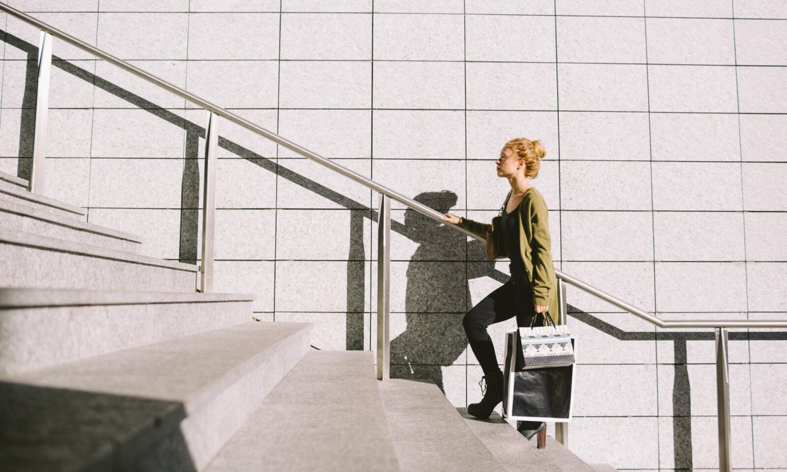 Person climbing a flight of stairs, symbolizing daily exercise and heart health benefits.