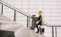 Person climbing a flight of stairs, symbolizing daily exercise and heart health benefits.