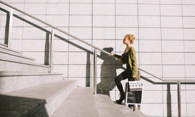 Person climbing a flight of stairs, symbolizing daily exercise and heart health benefits.