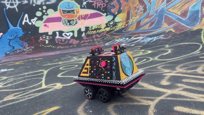 Custom 3D-printed Star Wars Mouse Droid with graffiti art, functioning as an autonomous rebel rave machine.