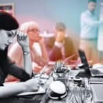 A diverse team collaborating with AI interfaces, symbolizing strategic workforce rebuilding post-layoffs.