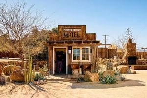 A stunning desert landscape at sunset, featuring a unique hotel blending into the environment.
