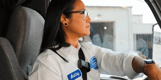 A Walmart truck driver smiling, representing a successful career path without college debt for Gen Z.