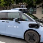 A Waymo Ojai fully autonomous ride-hailing vehicle drives on a city street in San Francisco.