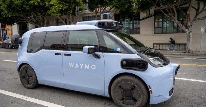 A Waymo Ojai fully autonomous ride-hailing vehicle drives on a city street in San Francisco.
