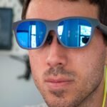 A person wearing sleek Xreal video glasses, immersed in a vibrant 3D movie experience.
