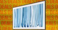 A Samsung Frame TV displaying artwork in a modern living room setting.