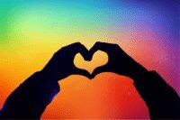 Person standing confidently in a diverse, supportive community, symbolizing self-acceptance and authenticity.