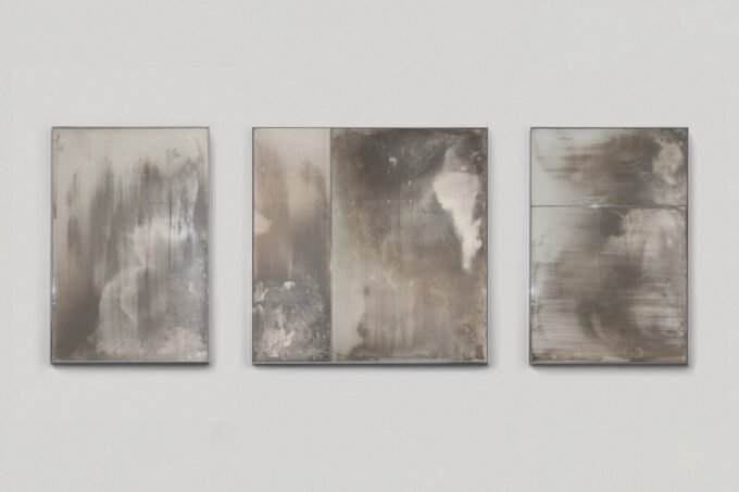 Three unique, handcrafted mirrors from Boldizar Senteski's 'Erosion Collection' displayed at StudioTwentySeven, showcasing oxidized surfaces and polished stainless steel frames.