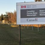 Canadian flags at half-staff in mourning after a military base fire in Alberta.