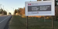 Canadian flags at half-staff in mourning after a military base fire in Alberta.