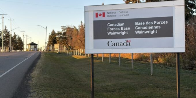 Canadian flags at half-staff in mourning after a military base fire in Alberta.