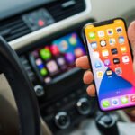 Apple's CarPlay Gets Smarter: iOS 27.2 Unveils Enhanced Siri and Revamped Podcasts 6 Apple CarPlay interface displaying navigation and media controls in a car dashboard.