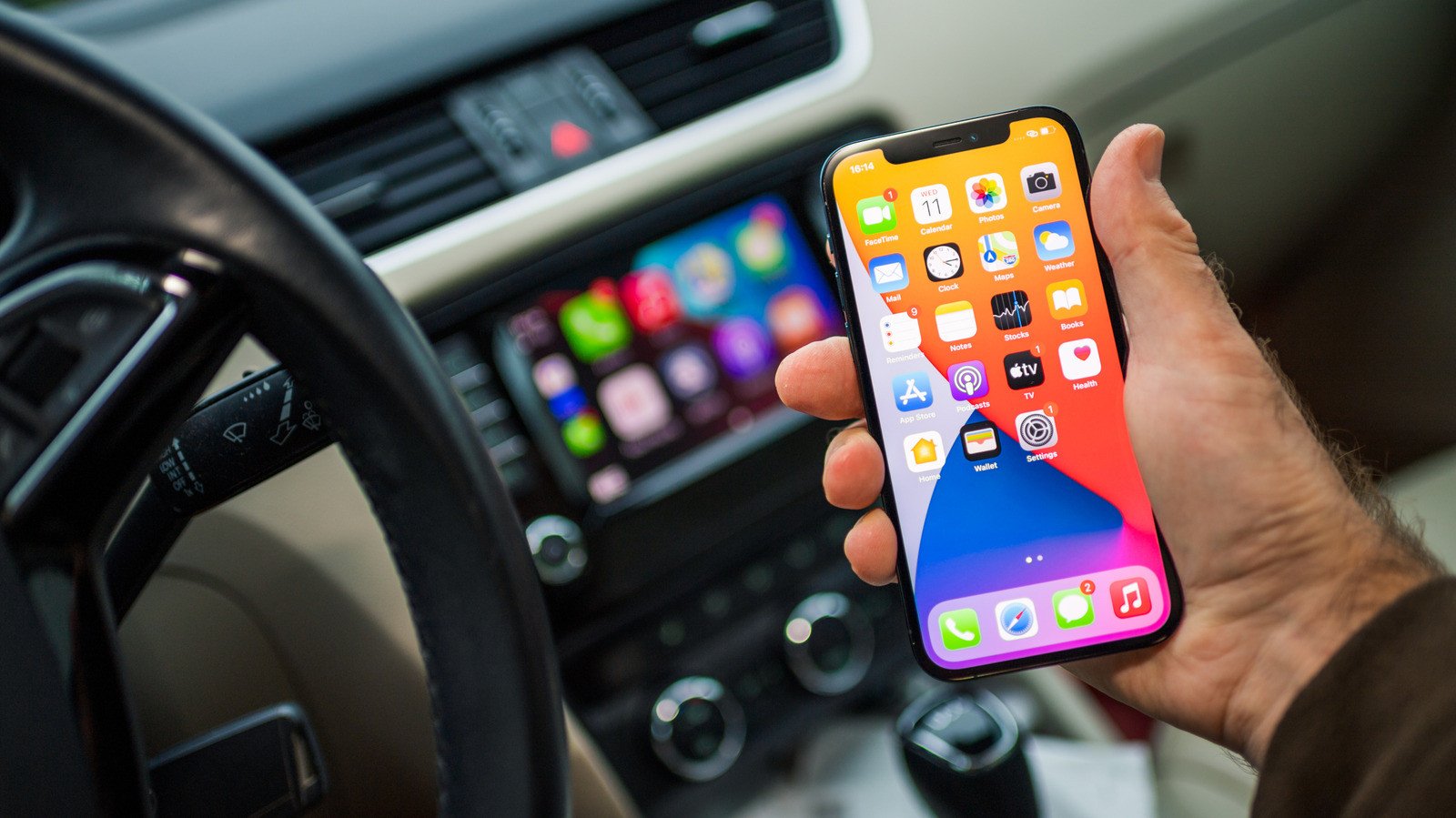 Apple CarPlay interface displaying navigation and media controls in a car dashboard.