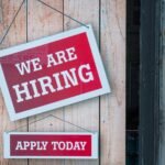 An illustration of job seekers and crypto logos, representing the surge in cryptocurrency job postings and the competitive talent market.