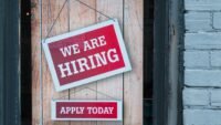 An illustration of job seekers and crypto logos, representing the surge in cryptocurrency job postings and the competitive talent market.