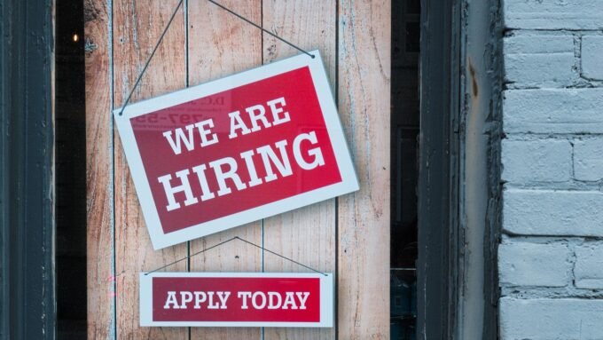 An illustration of job seekers and crypto logos, representing the surge in cryptocurrency job postings and the competitive talent market.