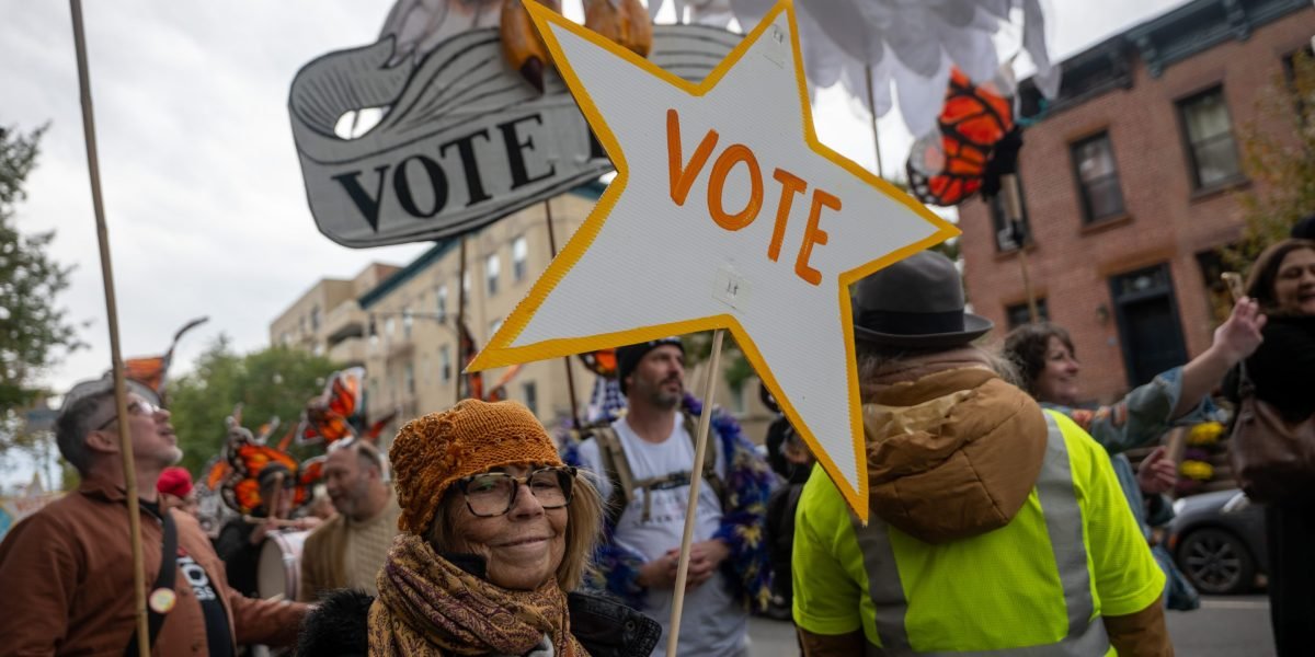 Democrats Eye Blue Wave Amidst Deep Divisions: The Brooklyn Brainstorm on Identity, AI, and Data Centers 3 A diverse group of people gathered in a phone-free room in Brooklyn, engaged in a political discussion with Post-it notes on the wall.