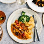 A vibrant, colorful array of diverse fruits, vegetables, grains, and proteins on a table, symbolizing a healthy and varied diet.