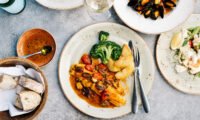 A vibrant, colorful array of diverse fruits, vegetables, grains, and proteins on a table, symbolizing a healthy and varied diet.