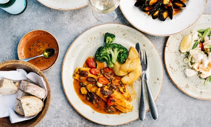 A vibrant, colorful array of diverse fruits, vegetables, grains, and proteins on a table, symbolizing a healthy and varied diet.