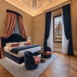 Elegant interior of Palazzo Sogni in Florence, showcasing a blend of historic frescoes and modern bespoke furniture.