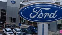 Ford F-Series pickup trucks on a dealership lot, representing U.S. auto sales.
