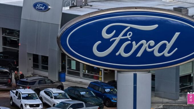 Ford F-Series pickup trucks on a dealership lot, representing U.S. auto sales.