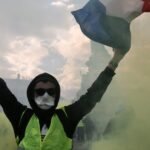 Protesters in France demonstrating amidst rising national debt and political gridlock.