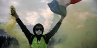Protesters in France demonstrating amidst rising national debt and political gridlock.