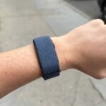 A close-up of the Garmin Cirqa smart band on a wrist, displaying a notification.