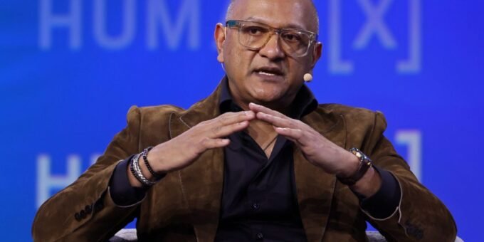 Cisco President Jeetu Patel shaking hands with Padmanabhan Krishnamurthy, symbolizing a generational shift in tech leadership.